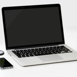 macbook pro near iphone and apple fruit